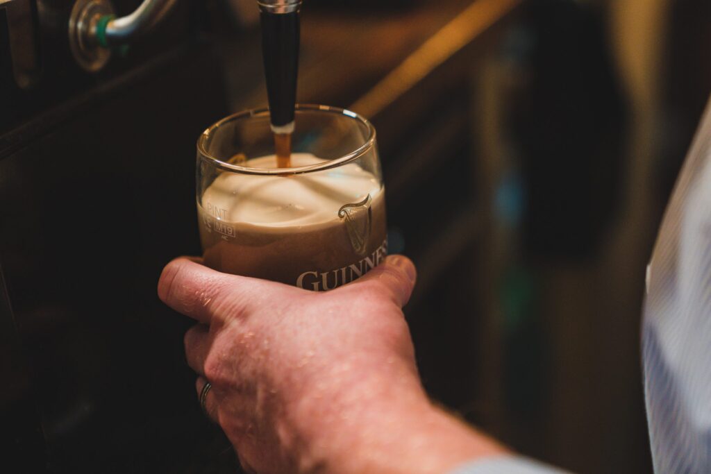 Pulling a pint of Guinness on draught at The Crowes