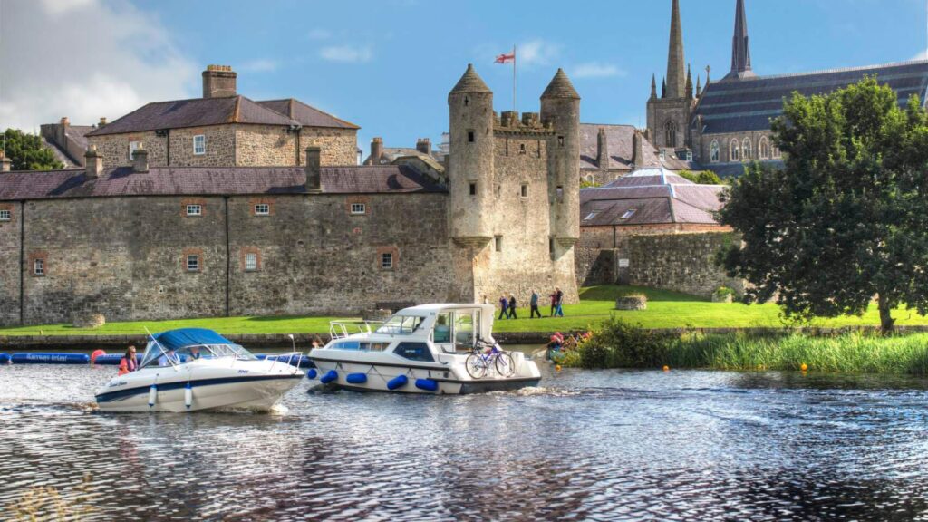 Summer getaway Enniskillen two boats on Lough Erne in front of Enniskillen Castle